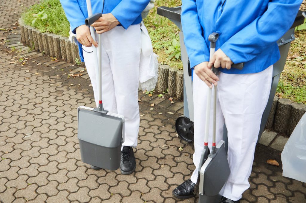 写真:アキバさんと団長@萌えさんが手に持つほうきとちりとり。