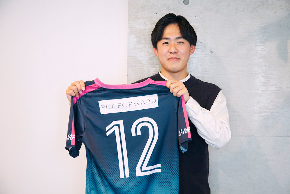 写真:ユニフォームを持つ小西さん