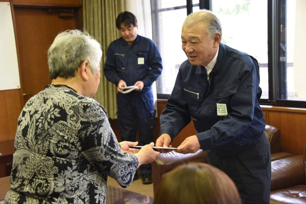 写真：熊本地震被災地での1シーン。被災者に見舞金を手渡す日本財団会長笹川。